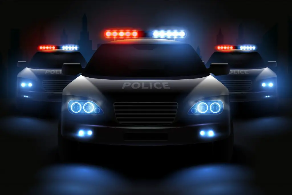 three police cars with lights on