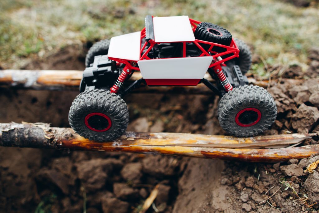 Rc car riding on wooden beams above hollow