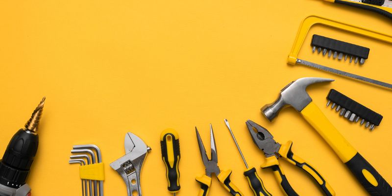 A picture of various tools on a yellow background